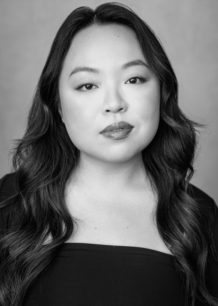 Headshot of Cindy Tsai, a woman with long, wavy hair, wearing a black top.