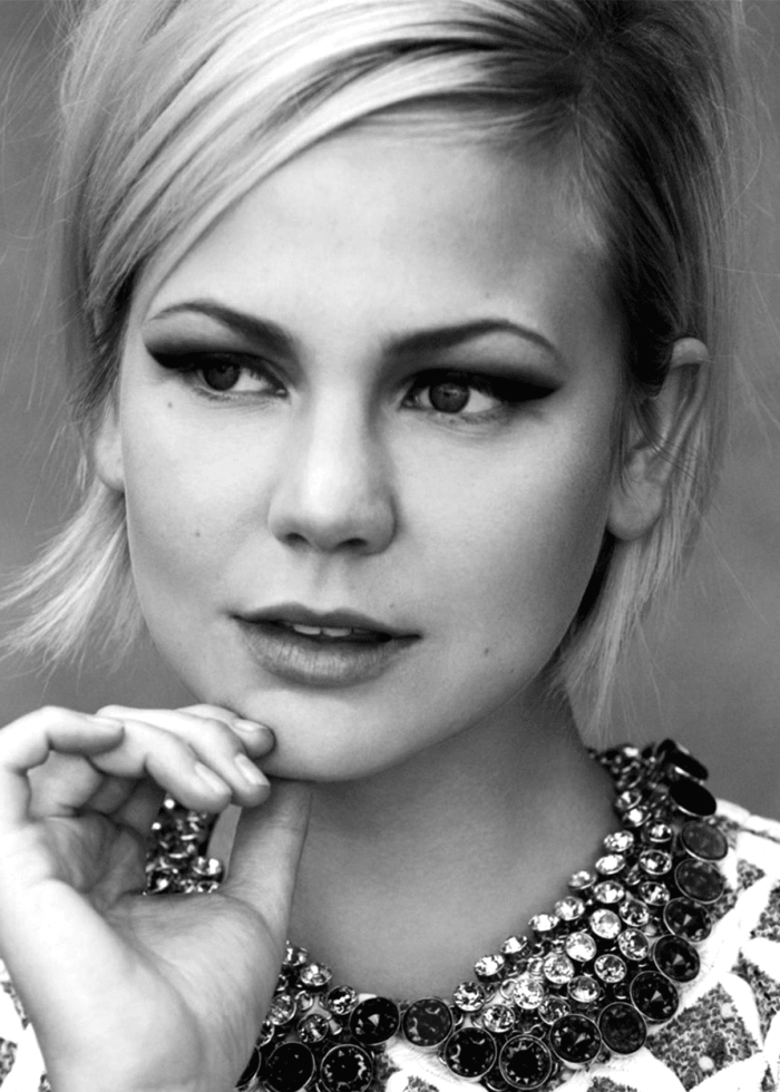 Adelaide Clemens in a black and white portrait, wearing a jeweled necklace and heavy eyeliner.