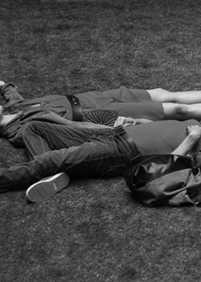 Couple relaxing on the ground. Scene from 'Cloud Nine,' a comedy of complicated couplings.