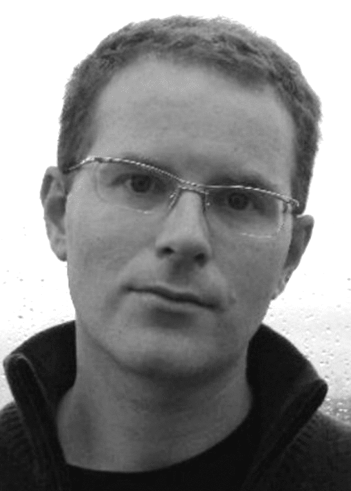 Conor McPherson, playwright, wearing glasses and looking at the camera.