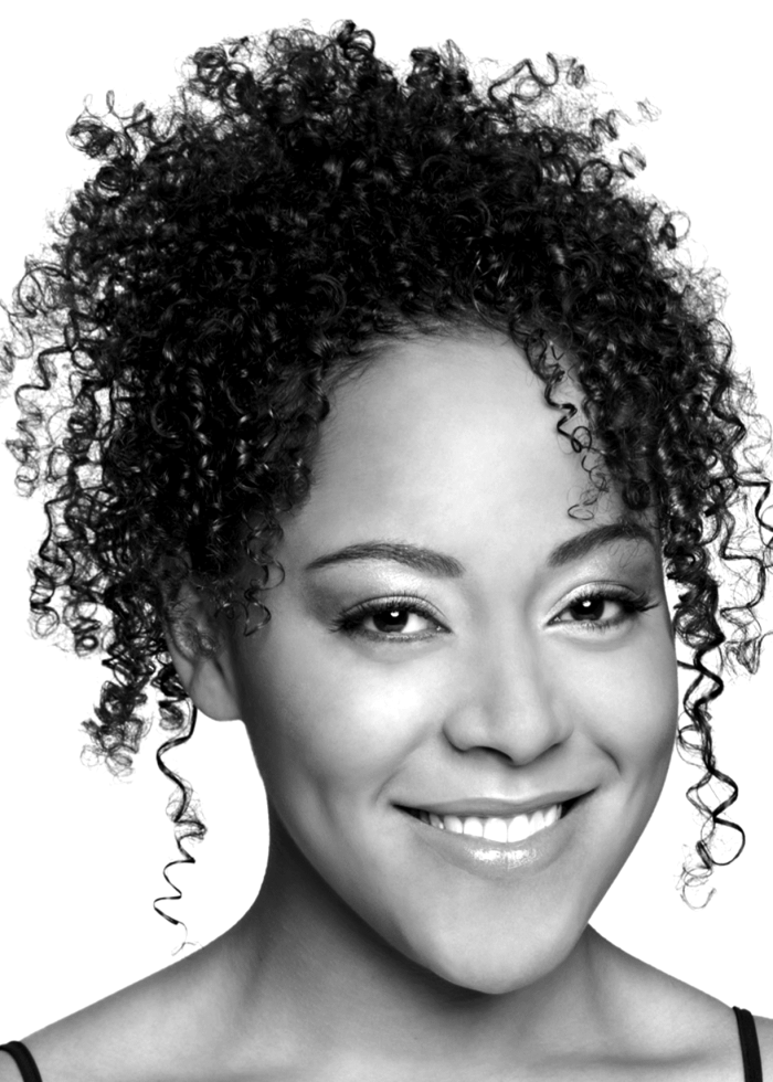 Lilli Cooper smiling, portrait with curly hair.