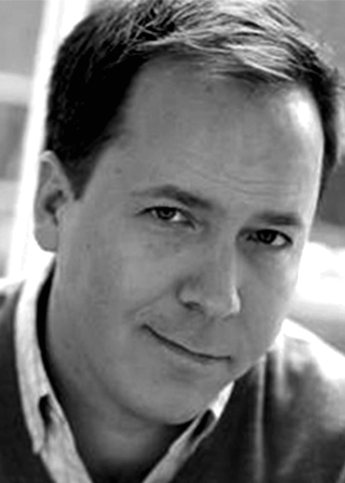 Portrait of a man with a slight smile, looking directly at the camera.