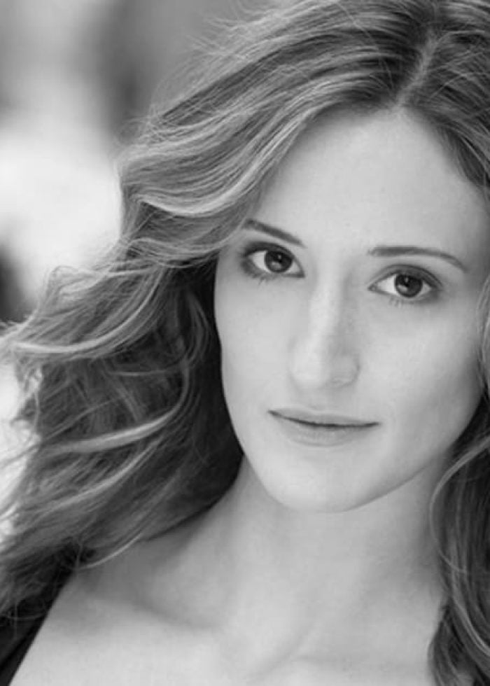 Headshot of Jessica Cummings with wavy hair, looking at the camera.