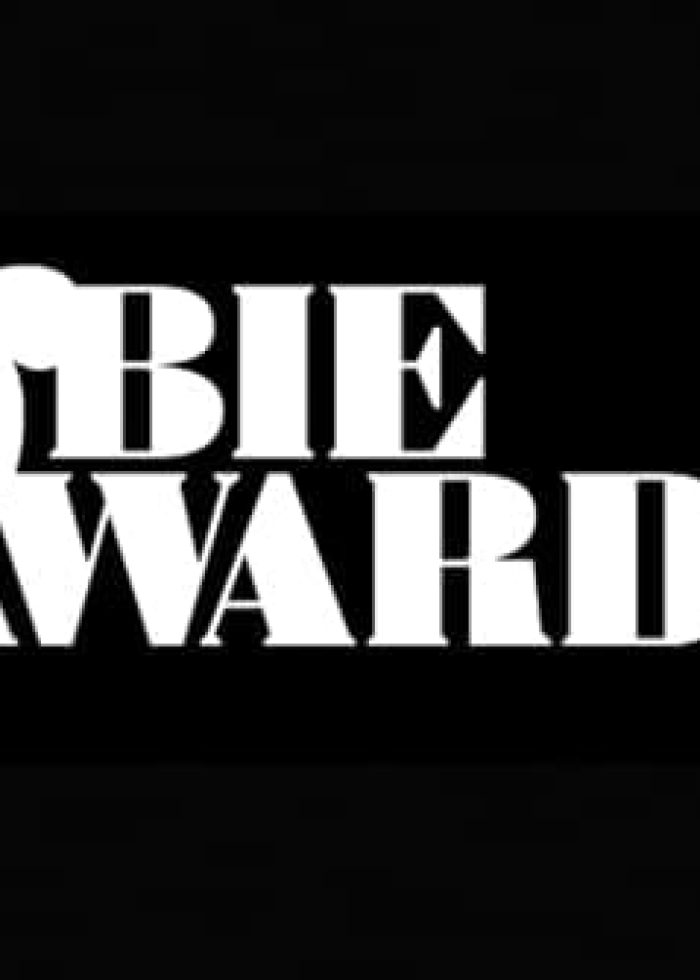 Obie Awards logo in white on black background. Awards for theater.