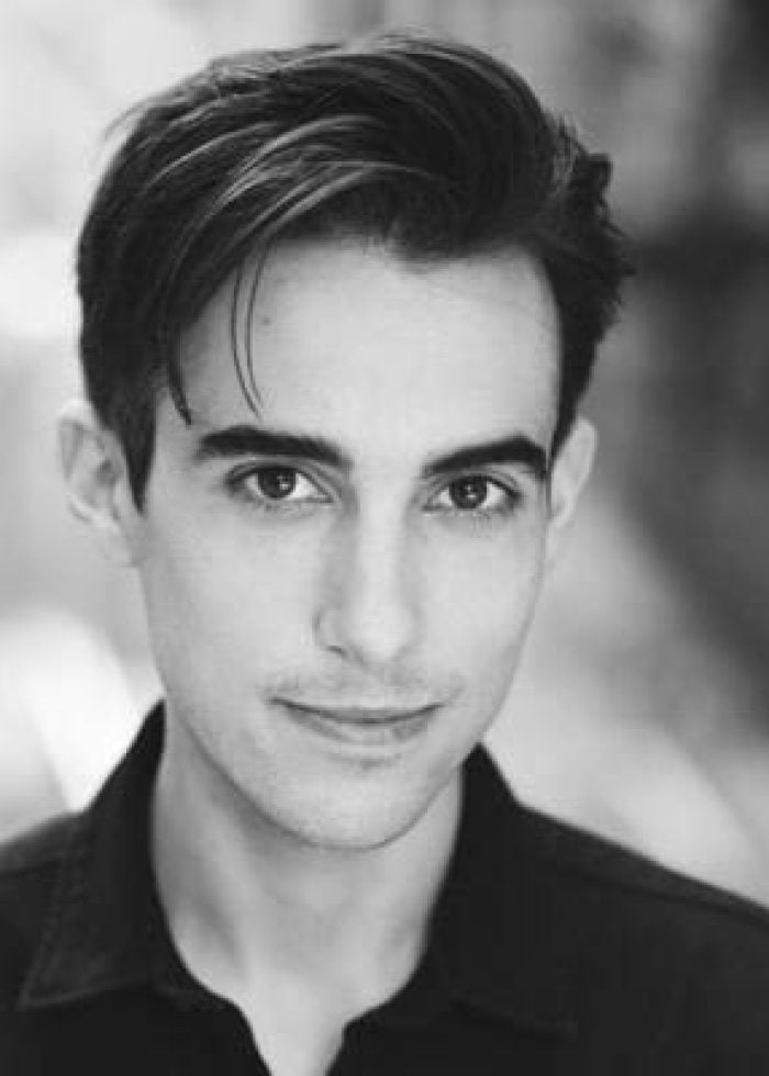 Justin Danforth in a black and white headshot, smiling