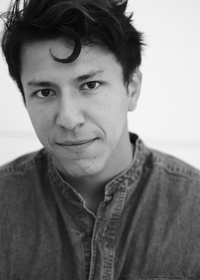 Portrait of Danny Lemache, a young man with dark hair and a denim shirt