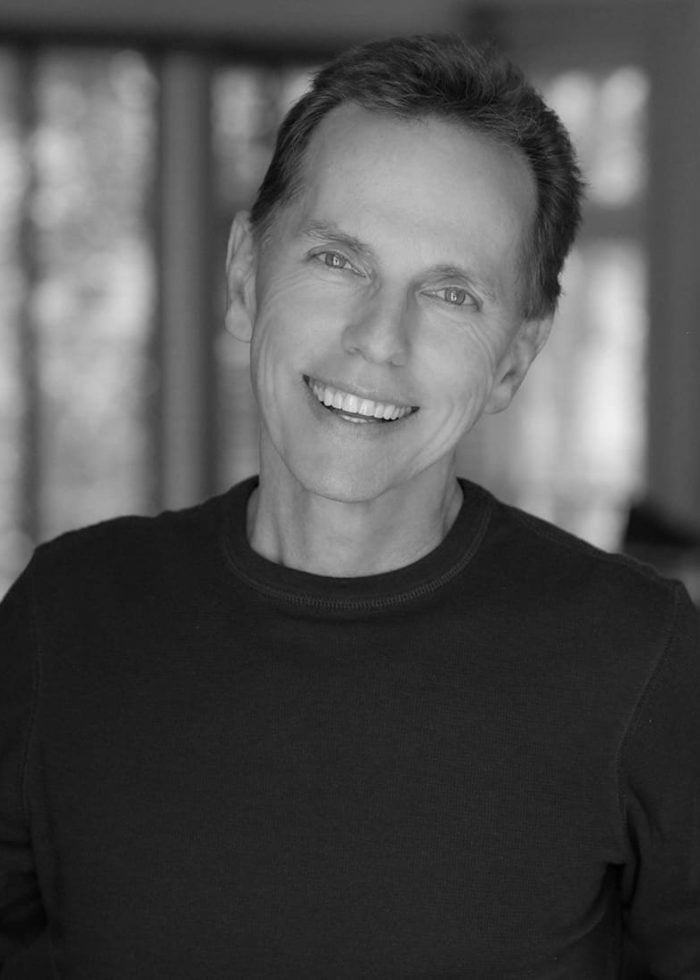 Dean Pitchford smiling, black and white portrait