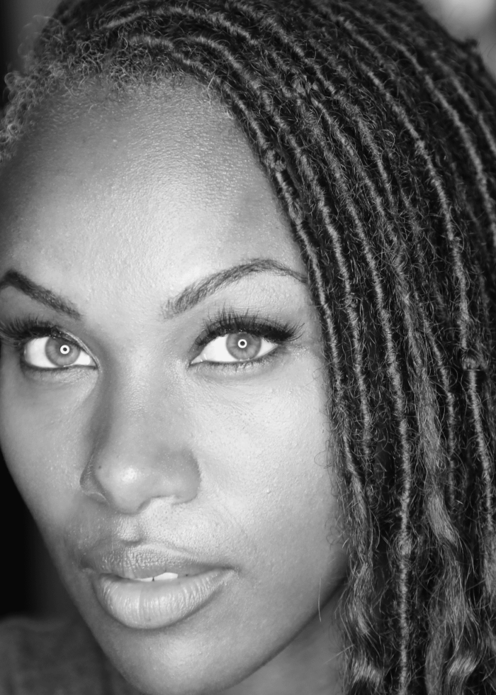 DeWanda Wise with long, textured hair and striking eyes, black and white portrait.