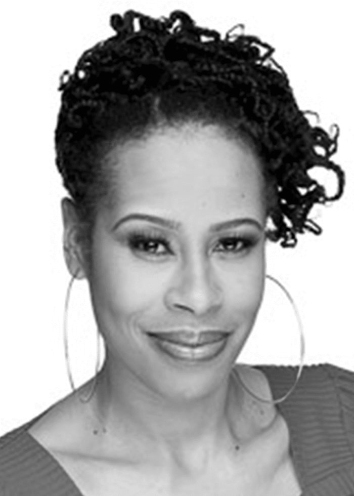 Dominique Morisseau, playwright and actress, smiling with large hoop earrings.