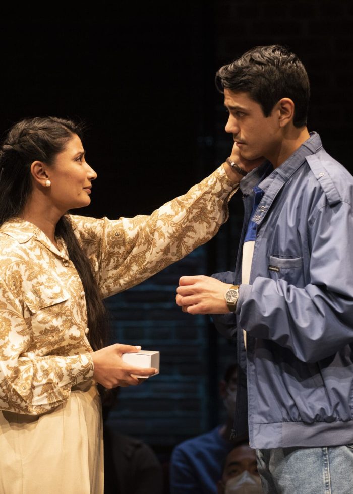 Actors on stage in a play, a woman touching a man's face. Edgerton Awards.