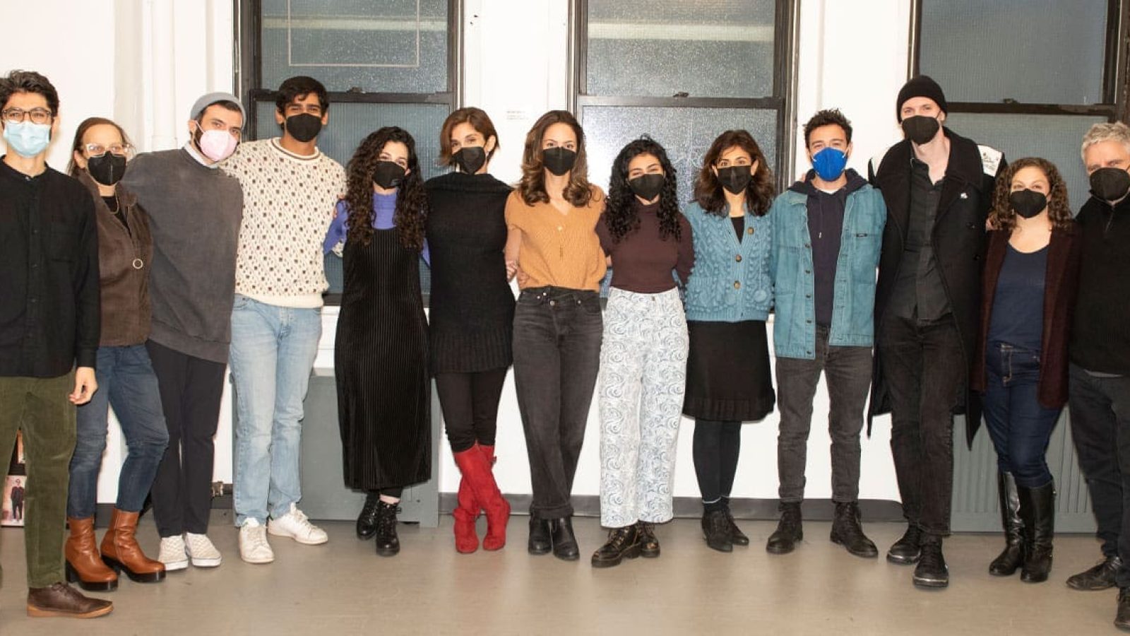 Cast and crew of an English-language play posing for a group photo.