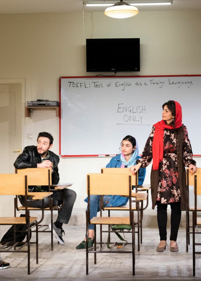 Cast of "English" play in a classroom, with "English Only" on the whiteboard.