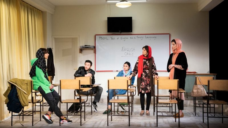 Cast of "English" play in a classroom, with "English Only" on the whiteboard.