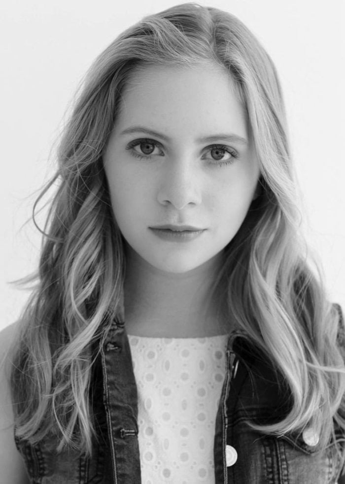 Elizabeth Teeter portrait, young actress with long blonde hair, wearing denim vest.