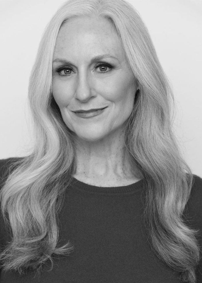 Elizabeth Ward Land headshot, smiling, silver hair, maroon sweater.