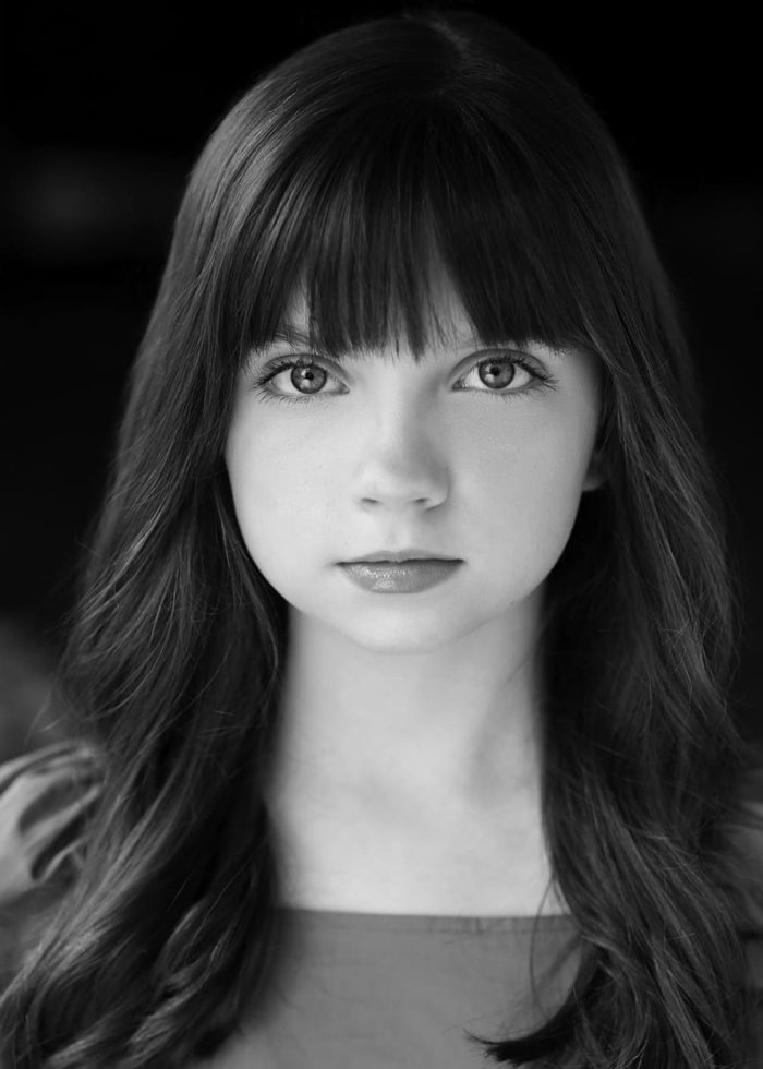 Ella Dane Morgan in a black and white headshot, looking directly at the camera.