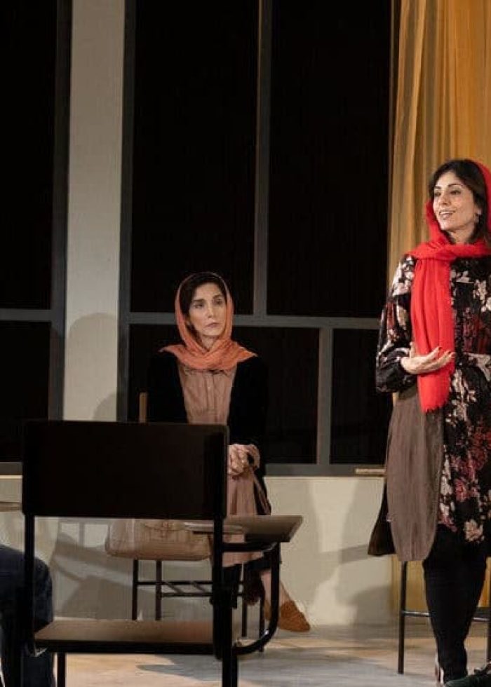 Actors in a classroom setting, part of the play "English," with a "Critic's Pick" seal.