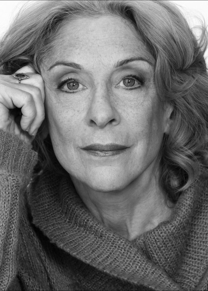 Laura Esterman portrait, close-up in black and white, wearing a sweater.