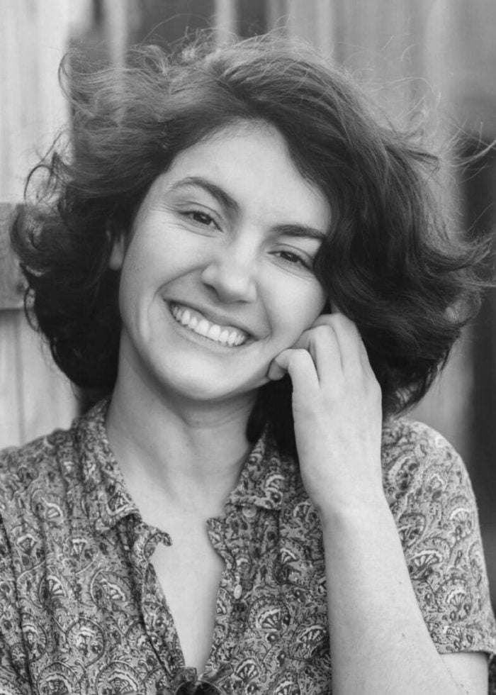 Fernanda Douglas, smiling woman with short curly hair and patterned shirt.