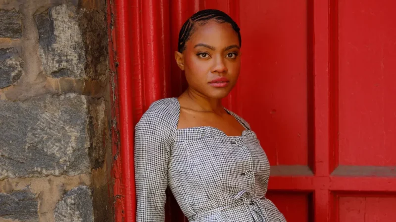 Gabby Beans leans against a red door in a houndstooth blazer, from the blog "Bold Enough to Go Full-Tilt