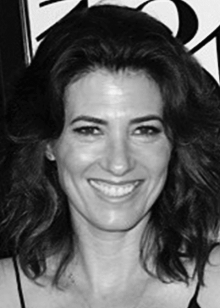 Gabrielle Allan smiling, medium shot, black and white portrait.