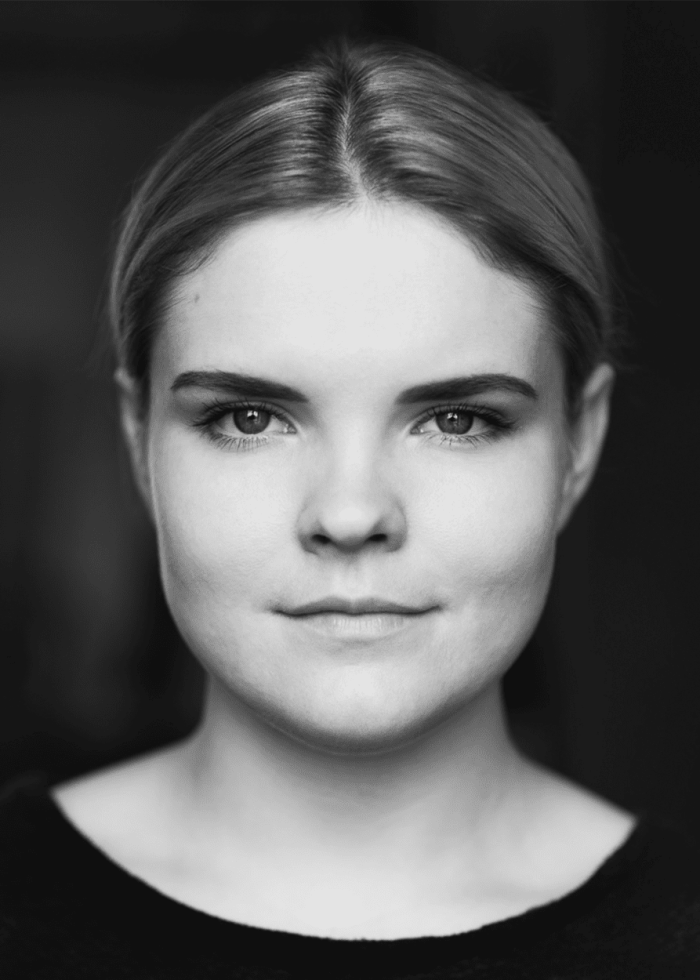 Gaby-French Black and white headshot of Gaby French, looking directly at the camera.