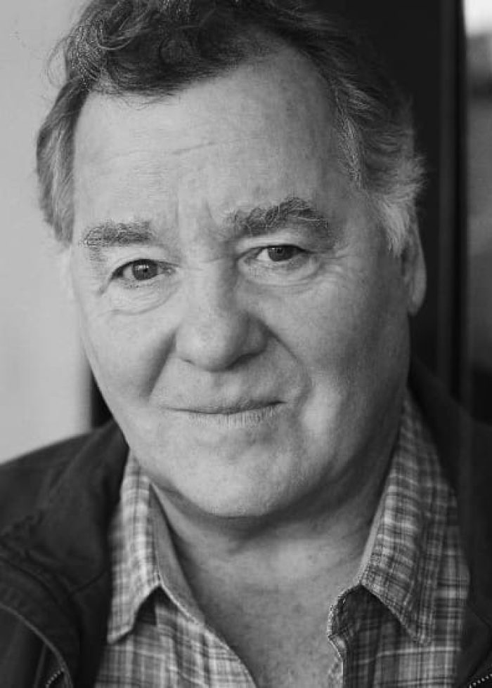 Peter Gerety in a black and white headshot, smiling slightly.