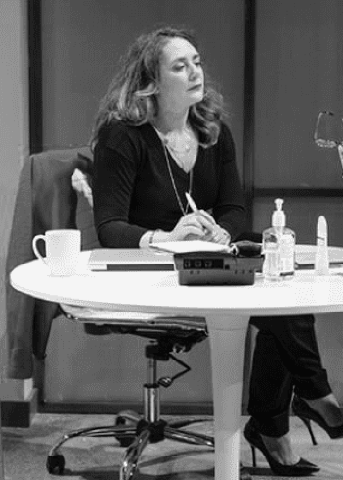 Three women in a scene from the play 'Good Television' discussing at a table.