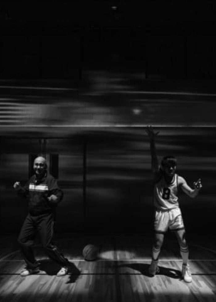 Cast of The Great Leap on stage, basketball court setting, dramatic lighting.