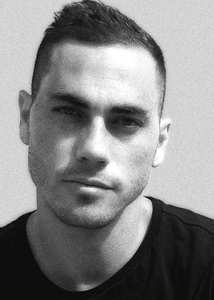 Close-up portrait of Greg Borowsky, a man with short dark hair and a serious expression