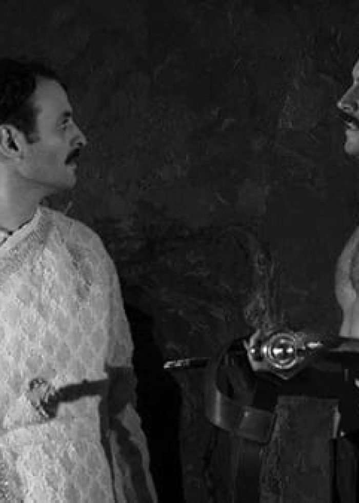 Two actors in Rajiv Joseph's "Guards at the Taj": a man with a sword and another in a robe.