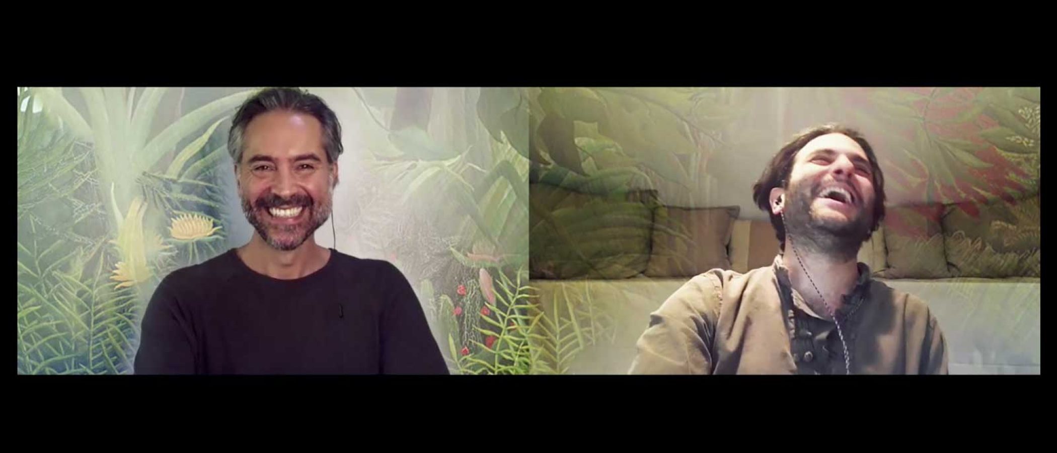 Two men video chatting, one smiling, one laughing.