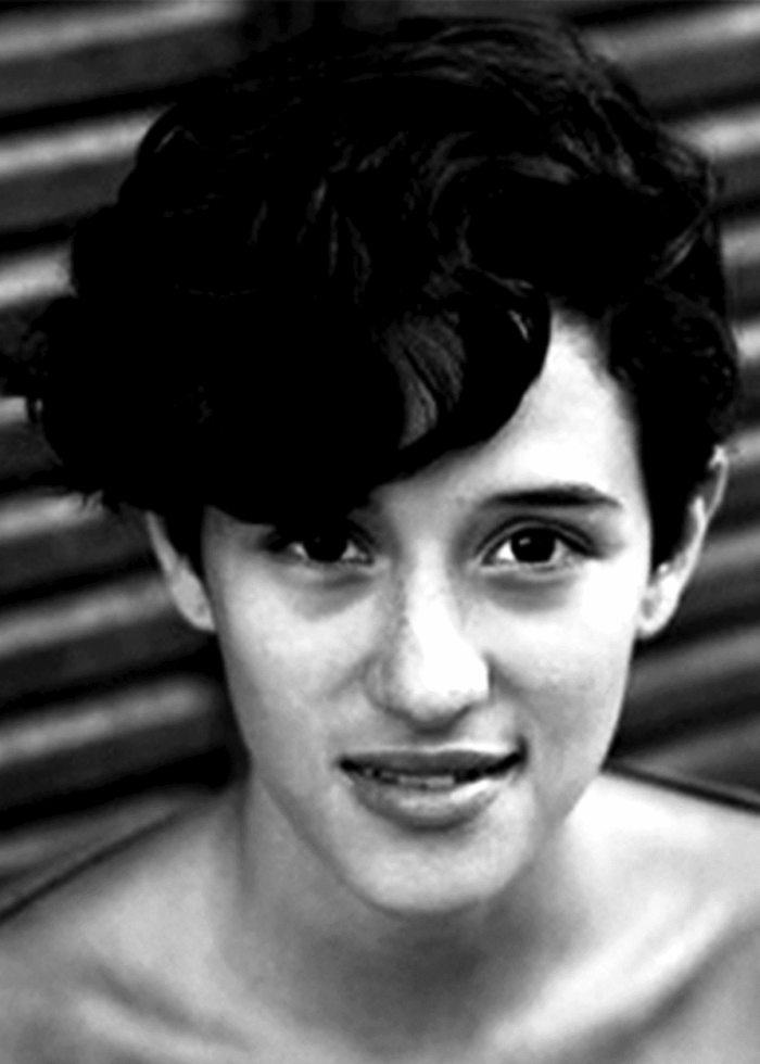 Close-up portrait of Yadira Guevara-Prip with dark curly hair, smiling