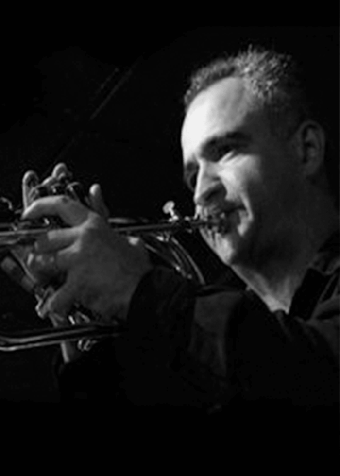 Guido Gonzalez playing the trumpet, a jazz musician performing.