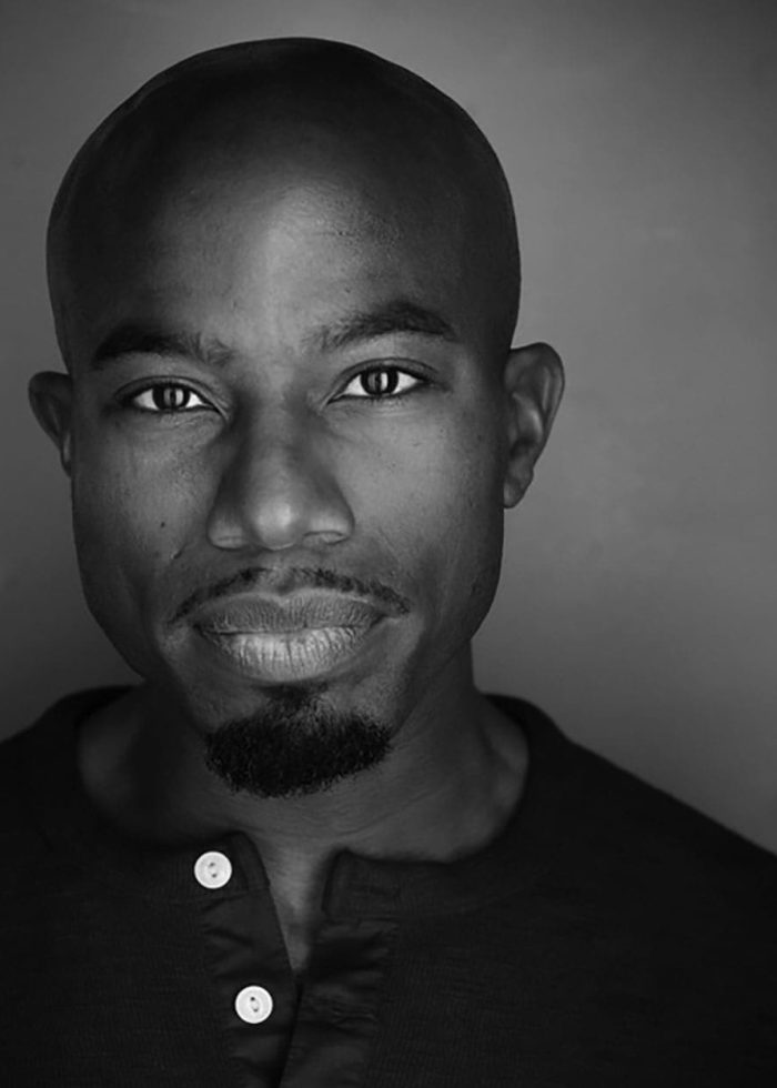 Close-up portrait of Guyviaud Joseph in black and white, looking directly at the camera.