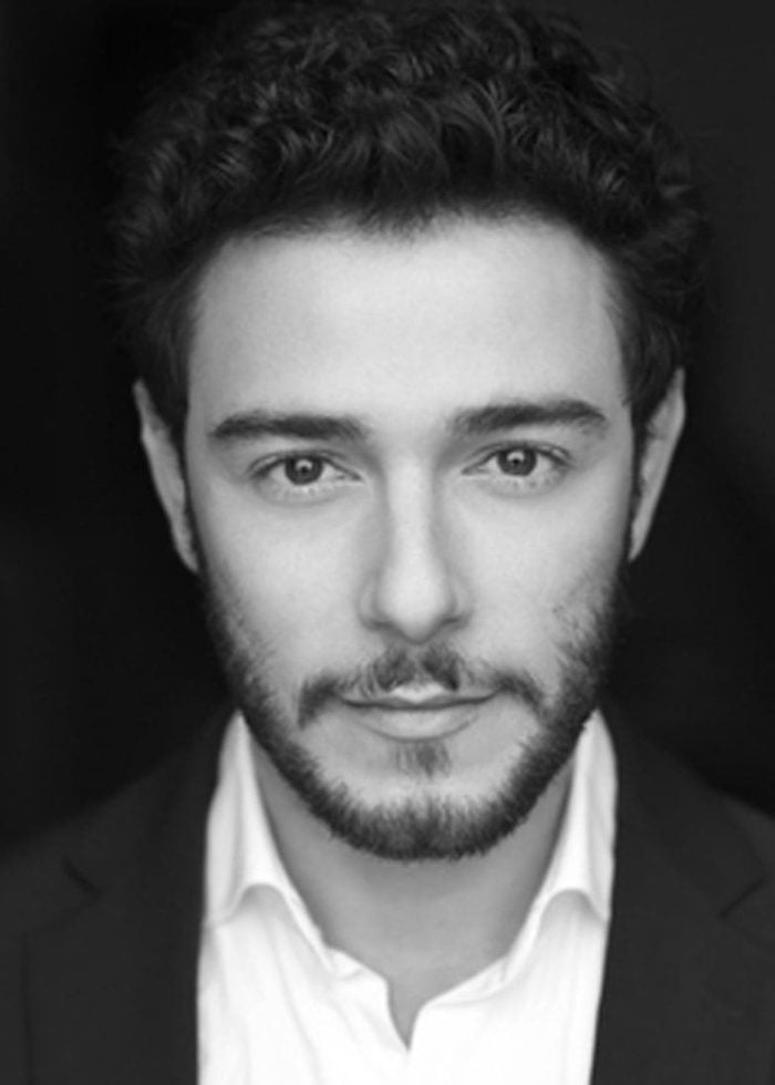 Black and white headshot of Hadi Tabbal, a man with curly hair and a beard.