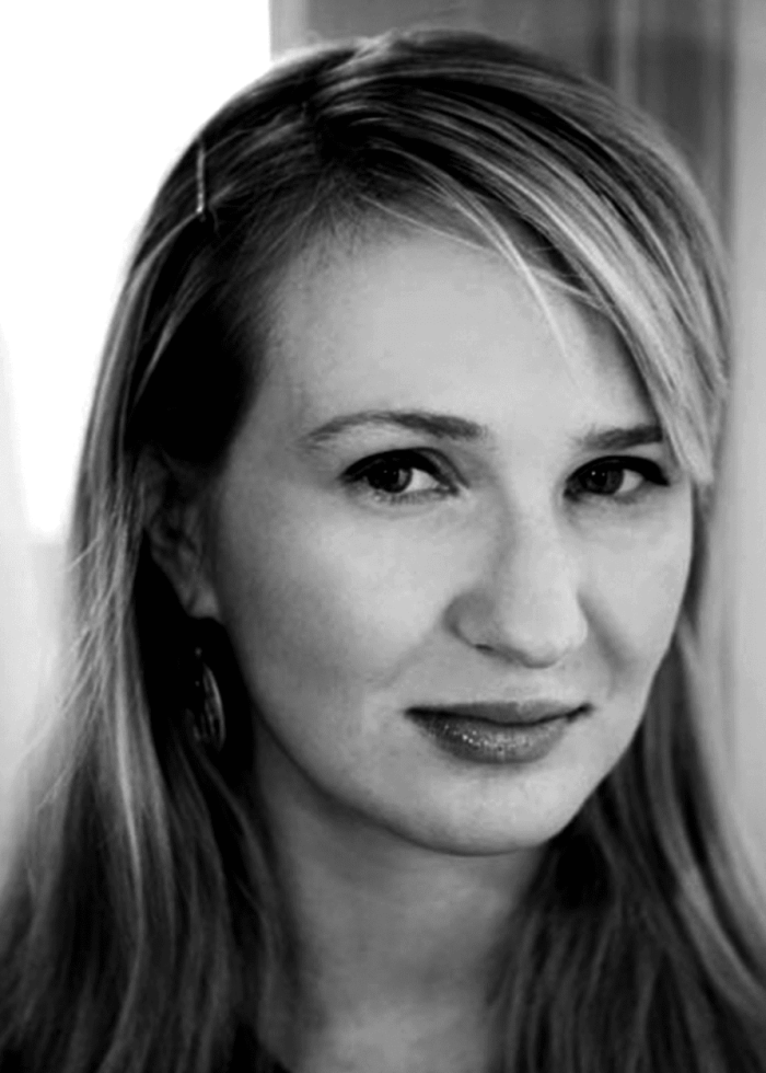 Halley Feiffer smiling, looking at the camera in black and white