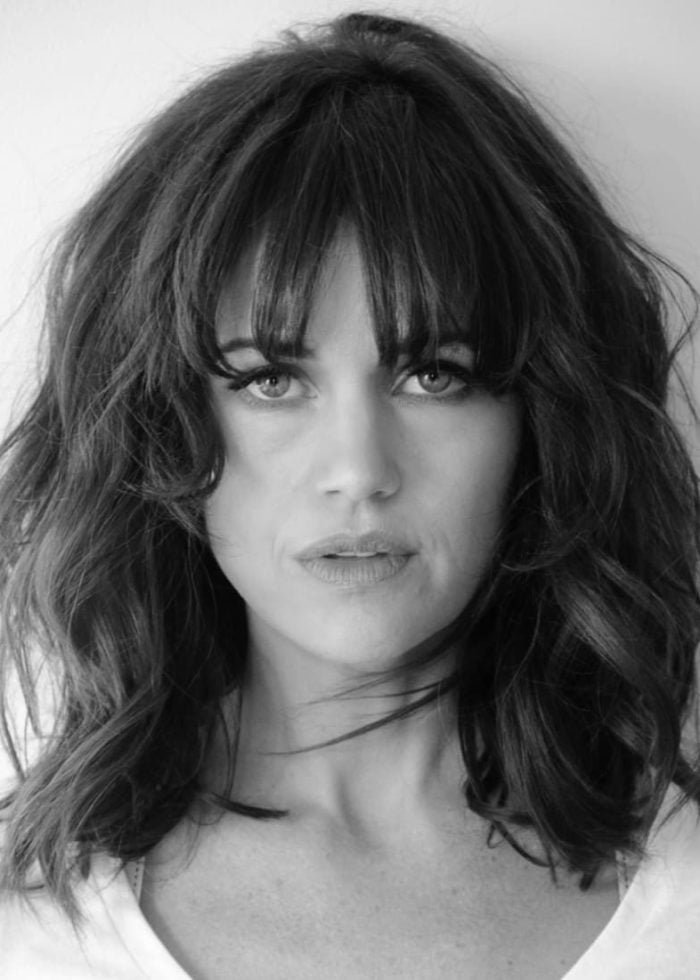 Headshot-Carla-Gugino_forweb Carla Gugino portrait with wavy hair and bangs, looking directly at the camera.