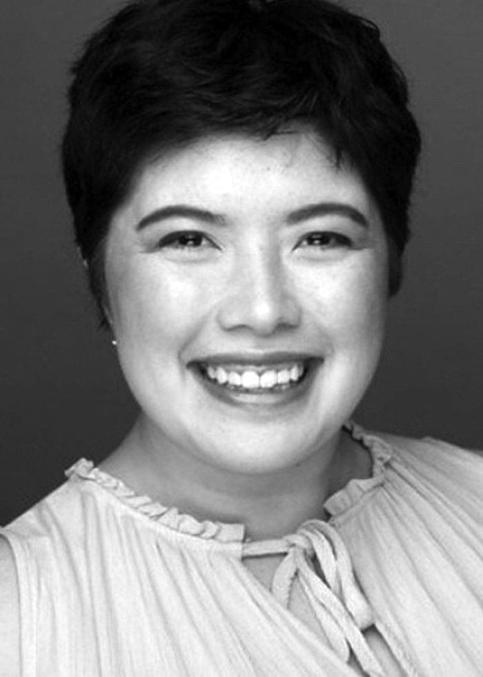 Heather Sawyer smiling, wearing a light-colored top, short dark hair.