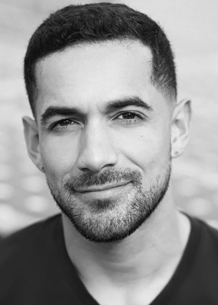 Héctor Juan Maisonet smiling, close-up portrait with short beard and hair.