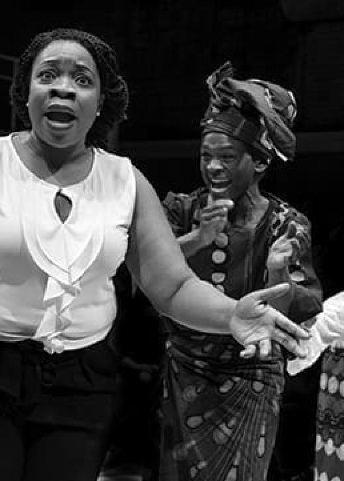 Three actresses performing on stage in a scene from "The Homecoming Queen.