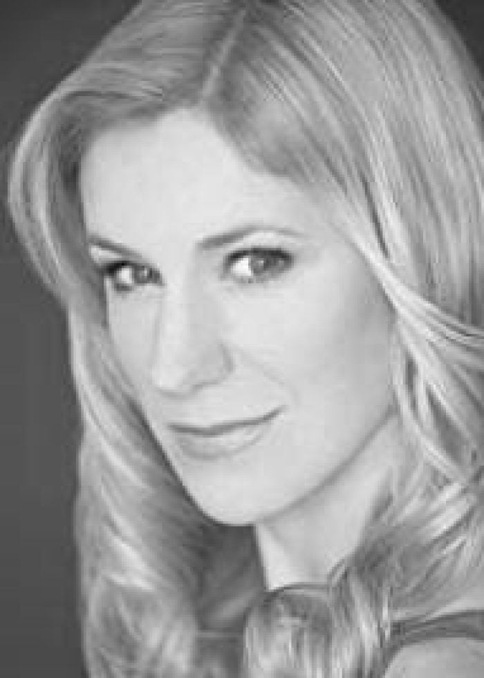 Charlotte Parry, actress with blonde hair, looking towards the camera