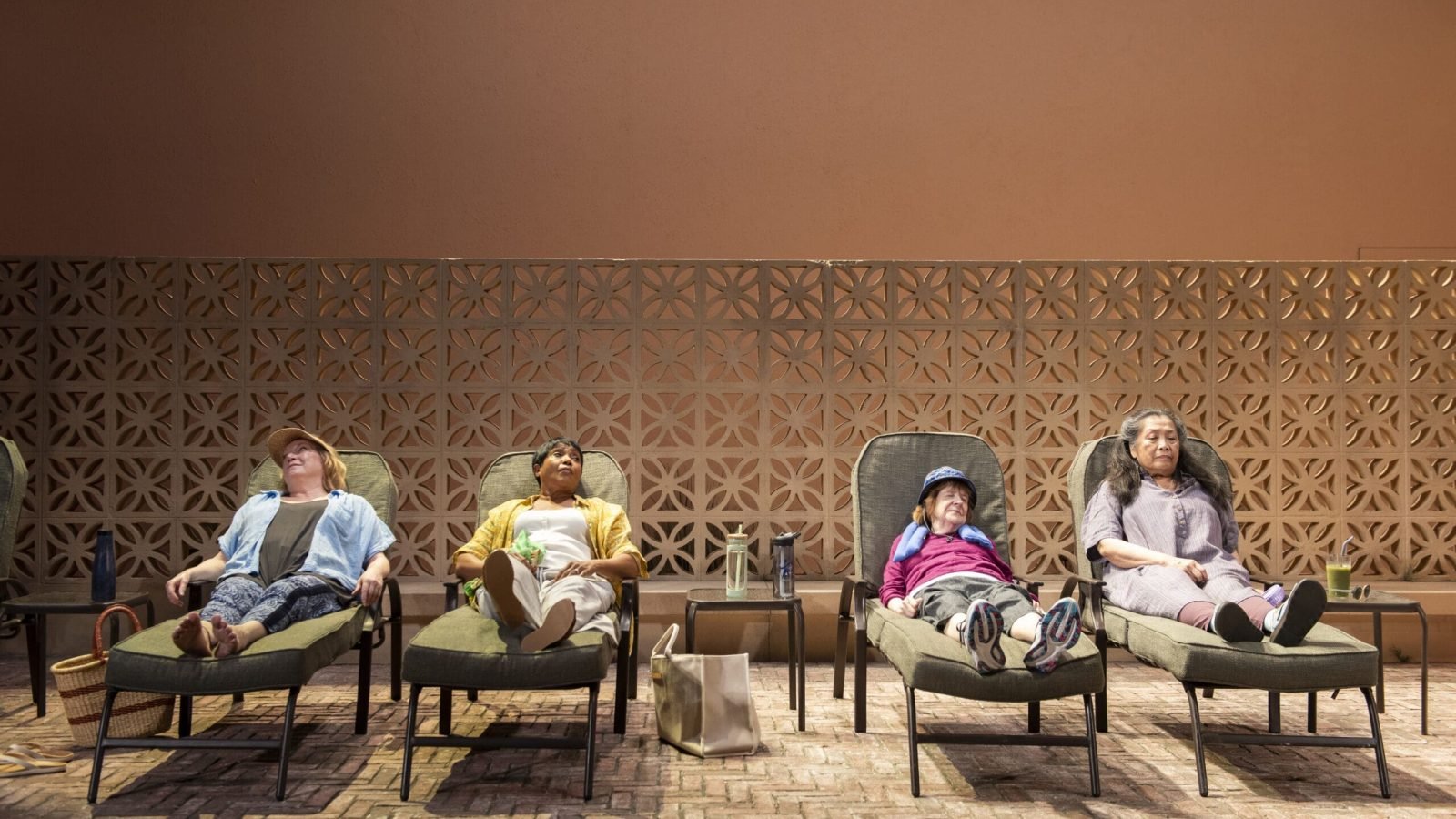 Four women relax on lounge chairs, enjoying infinite life's simple pleasures.