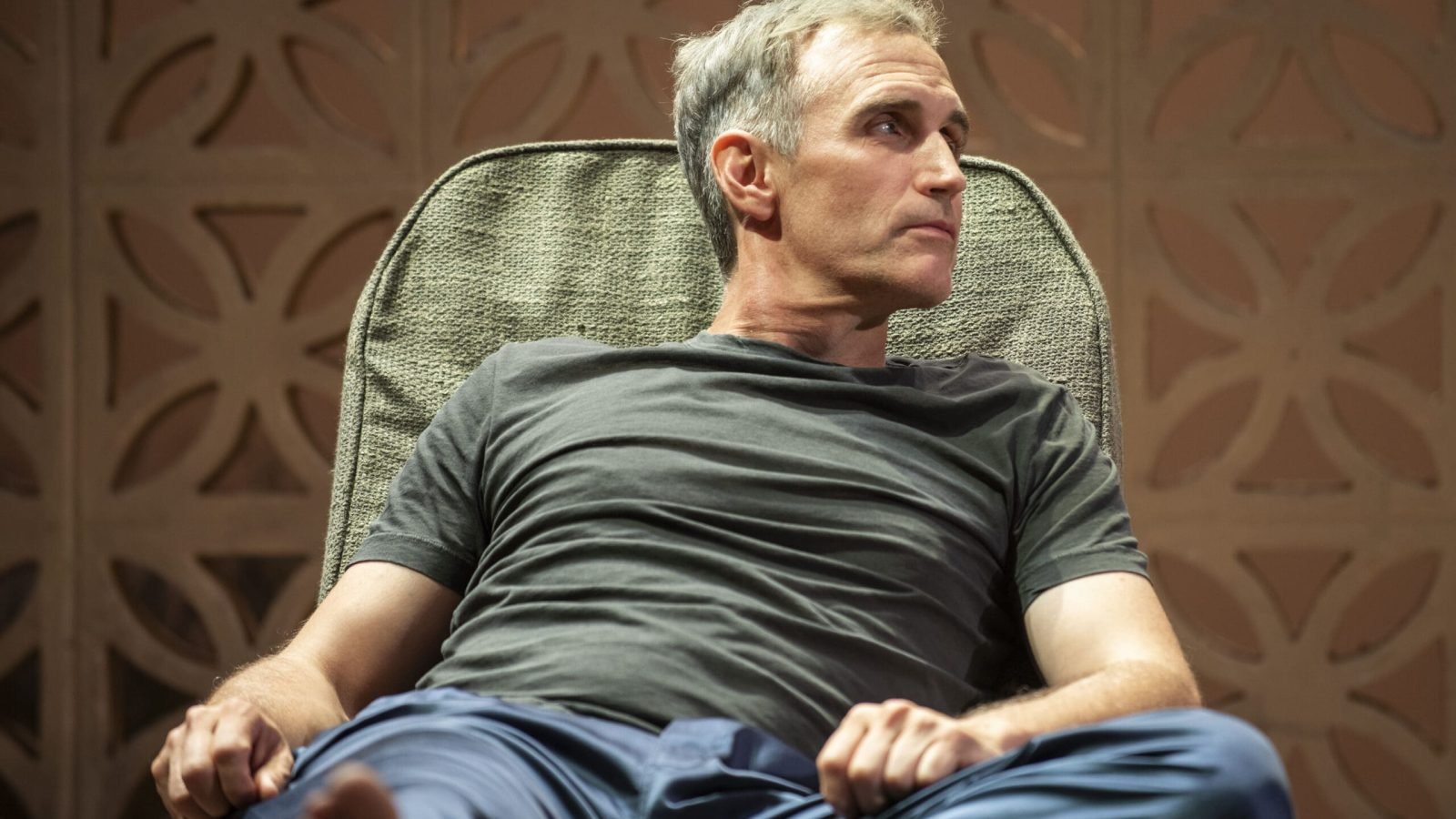 Middle-aged man relaxing in a chair, contemplating infinite life.