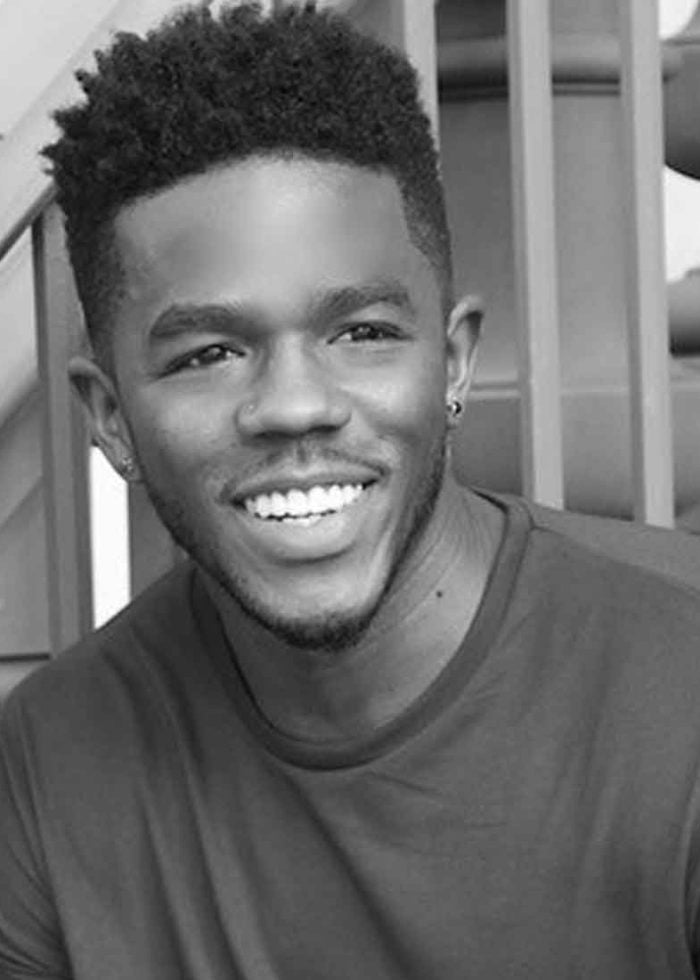 Ian Duff smiling, wearing a dark shirt and short, textured hairstyle.