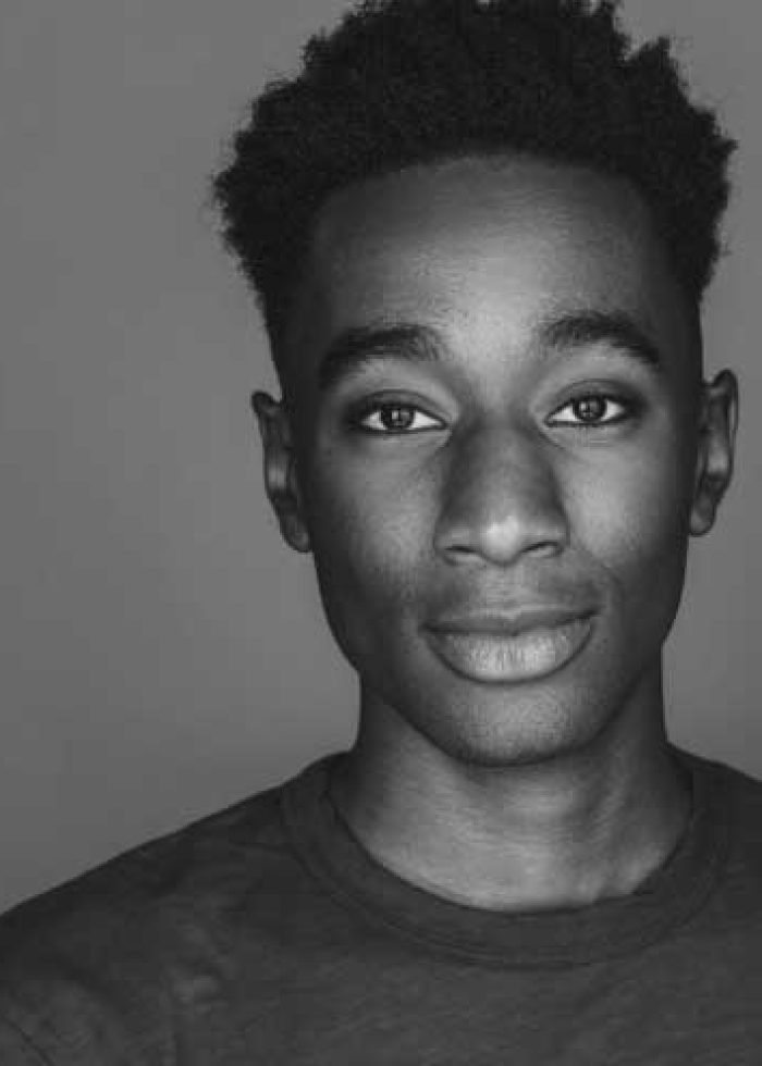 Jaevon Williams, a young man with short, dark hair, looks directly at the camera.