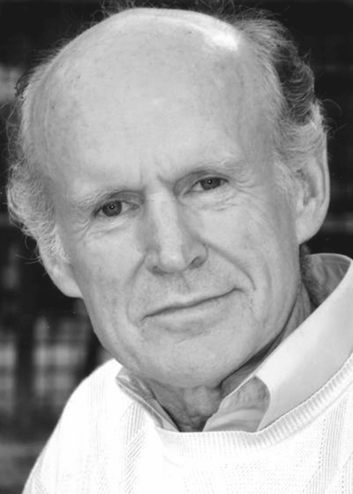 James Murtaugh, a distinguished man in a white sweater, looking directly at the camera.