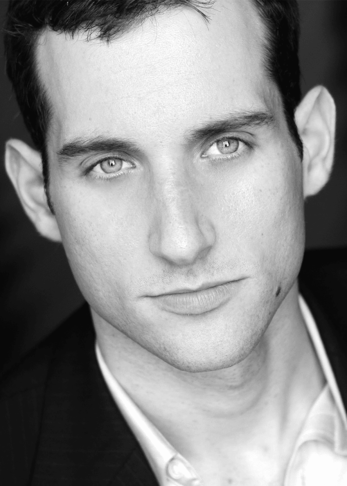 Black and white headshot of James Stafford, looking intently at the camera.