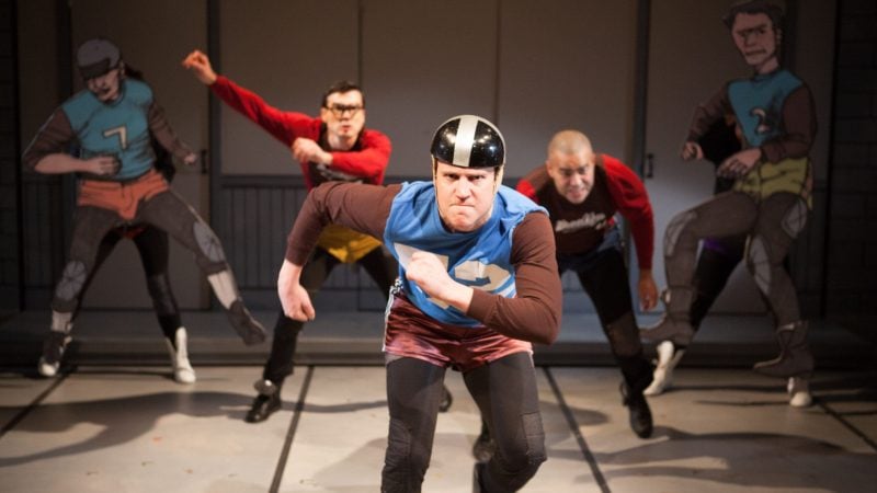 Actors in colorful costumes performing a play, possibly about membership.