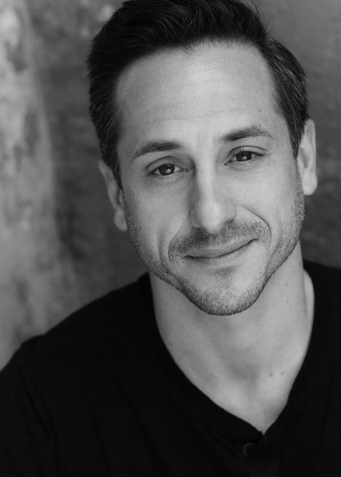 Jason Babinsky smiling in a headshot, wearing a black shirt